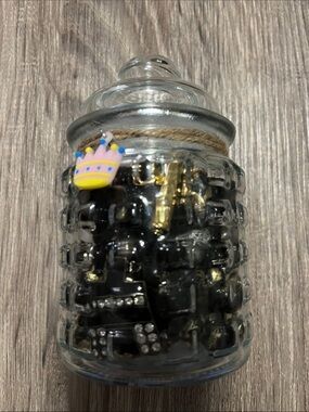 Glass Jar Filled with Black and Gold jewelry